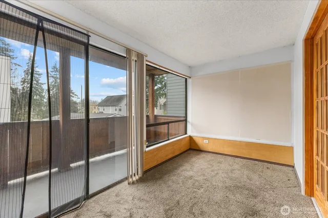 a dining room with furniture and a window