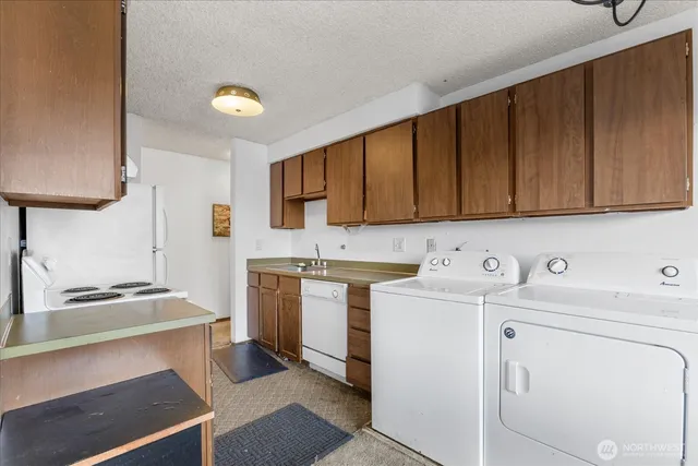 a view of storage and utility room with washer and dryer