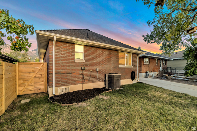 Undisclosed Address Ogden, UT 84403 - Photo 4 of 21 Back of property with a fenced backyard, brick siding, a shingled roof, and a gate
