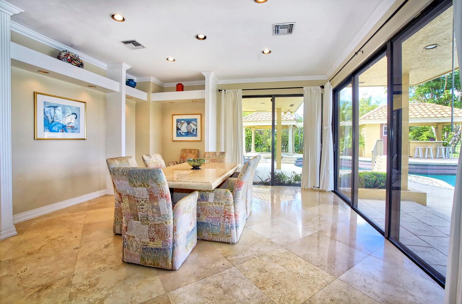 21125 Hamlin Drive Boca Raton, FL 33433 - Photo 11 of 69 a dining room with wooden floor and large windows