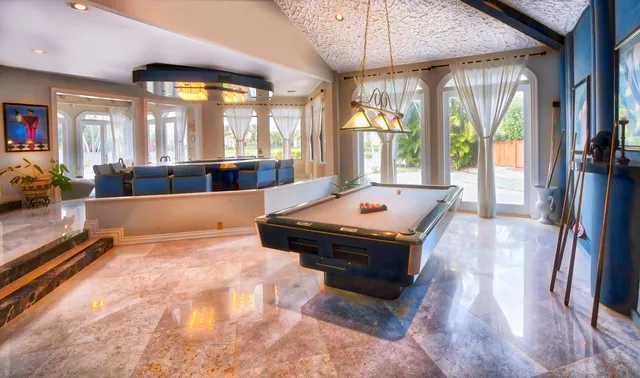 a view of a bedroom with a bed and wooden floor