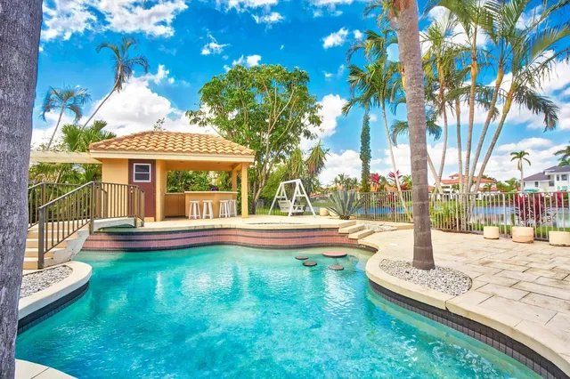 an aerial view of a city with lots of residential buildings ocean and mountain view in back