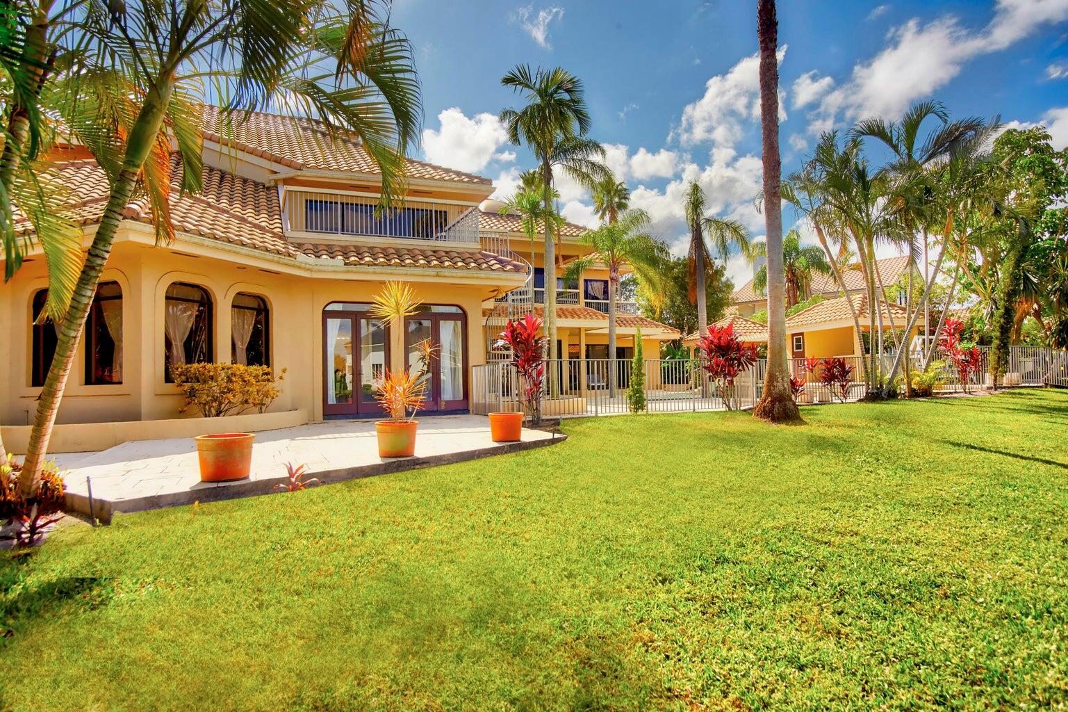 21125 Hamlin Drive Boca Raton, FL 33433 - Photo 36 of 69 front view of a building with a yard