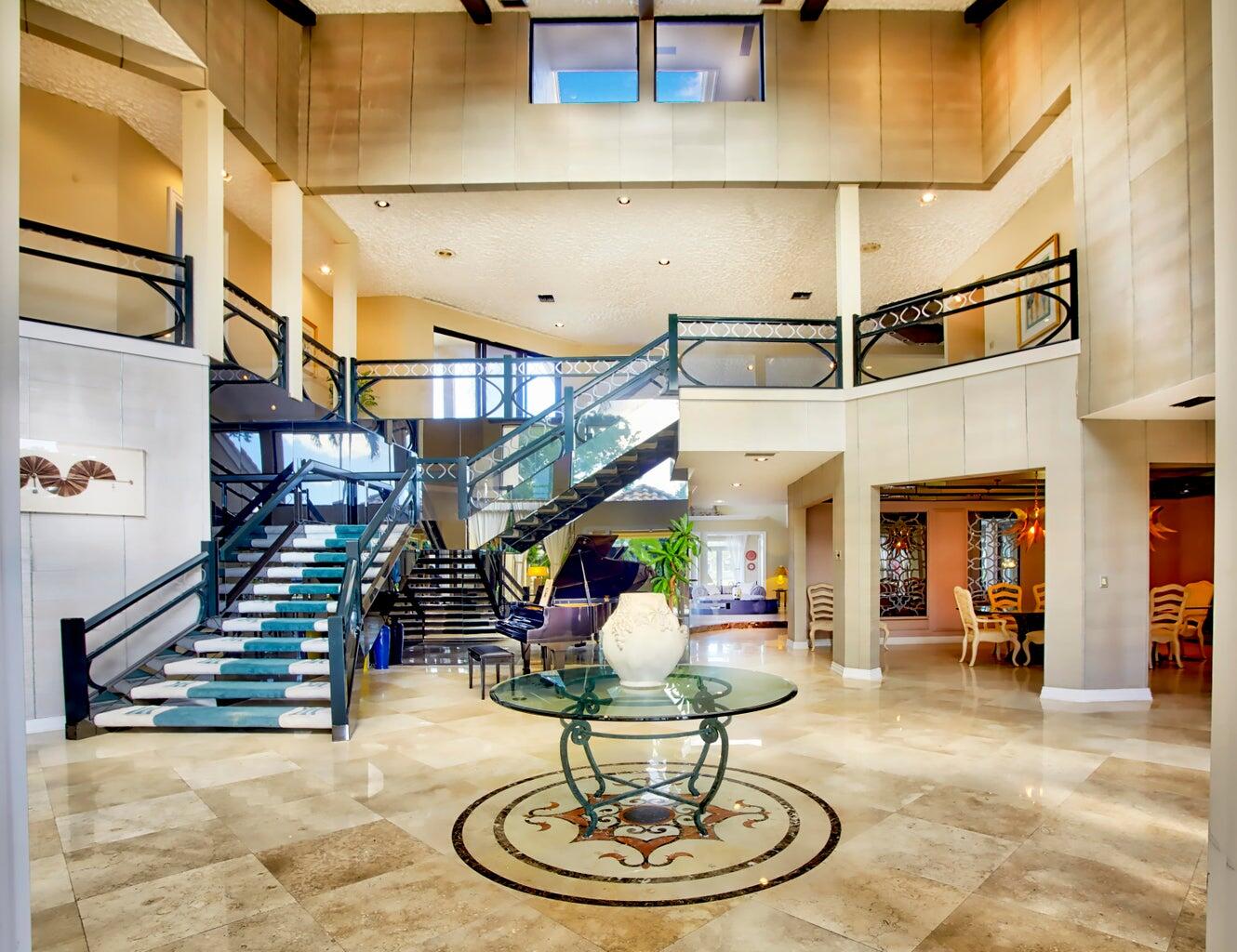 21125 Hamlin Drive Boca Raton, FL 33433 - Photo 5 of 69 a living room with lots of gym equipment and a chandelier