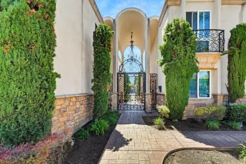 a view of a house with brick walls and plants