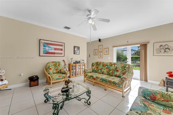 a living room with furniture and painting on the wall