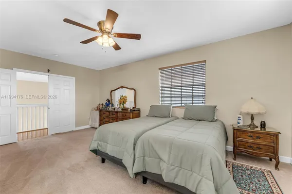 a bedroom with a bed and window