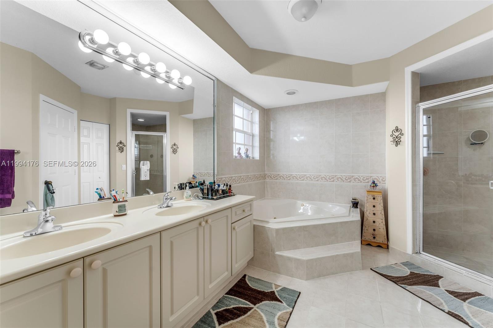 6502 Southwest 157th Court Miami, FL 33193 - Photo 19 of 51 a bathroom with a tub a sink and mirror