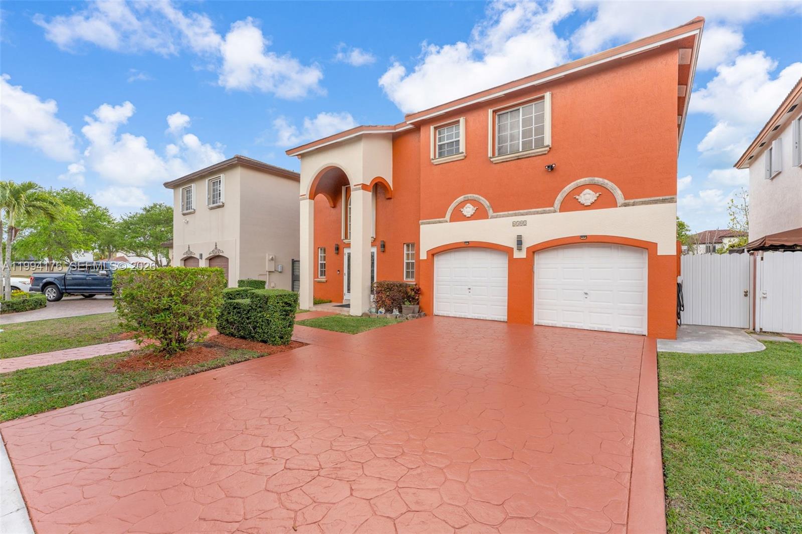 6502 Southwest 157th Court Miami, FL 33193 - Photo 2 of 51 a front view of a house with a yard garage and outdoor seating