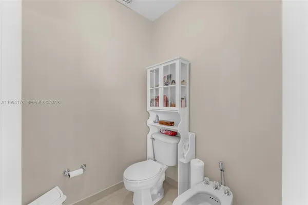 a white toilet sitting next to a bathroom sink