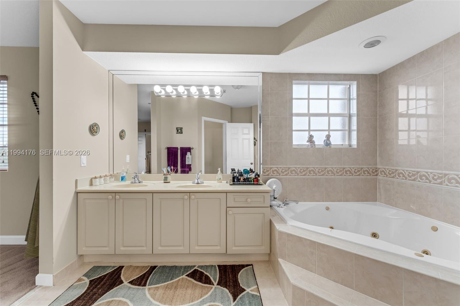 6502 Southwest 157th Court Miami, FL 33193 - Photo 22 of 51 a bathroom with a bathtub a sink and a mirror