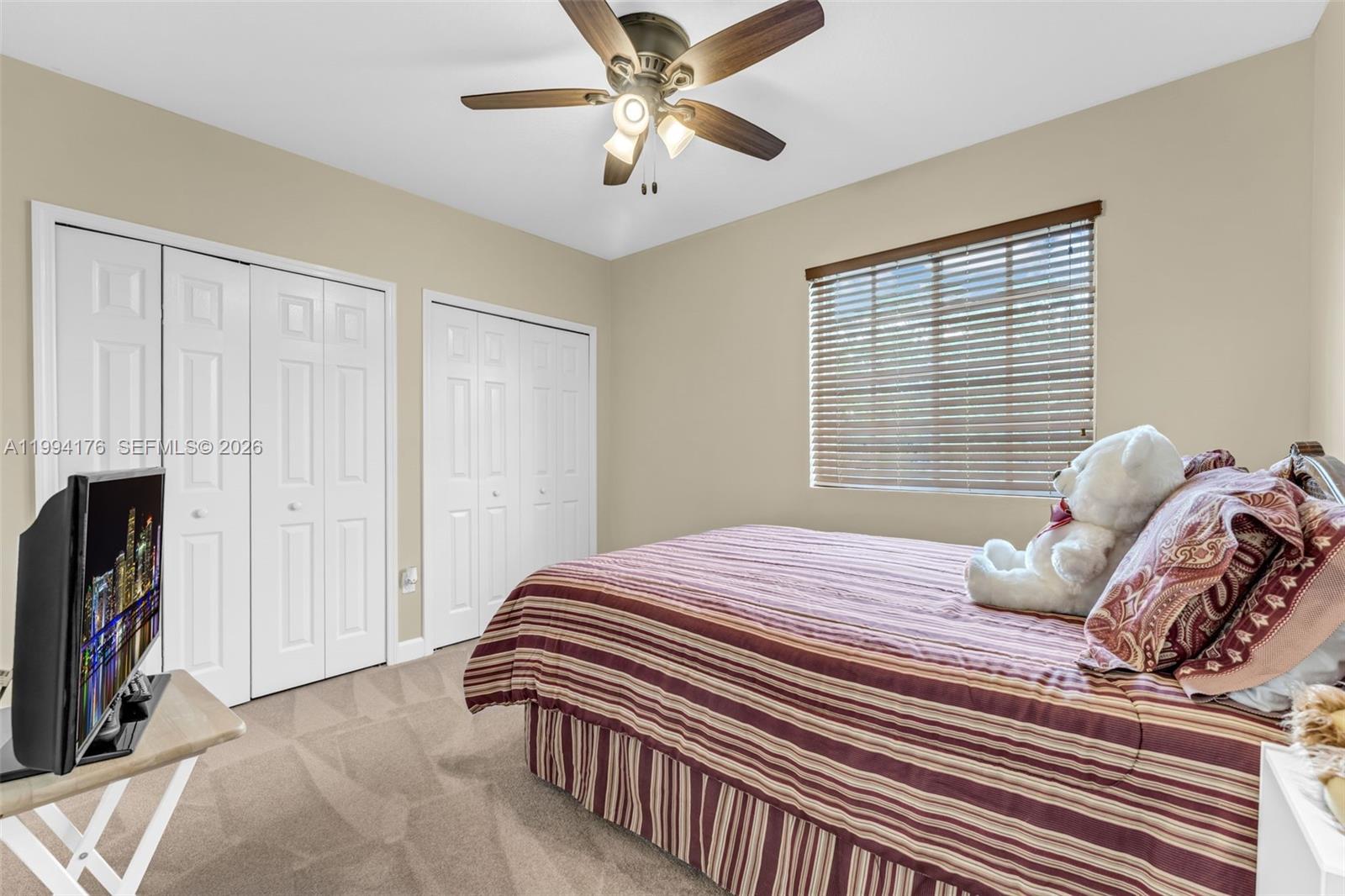 6502 Southwest 157th Court Miami, FL 33193 - Photo 29 of 51 a bedroom with a bed and a chandelier