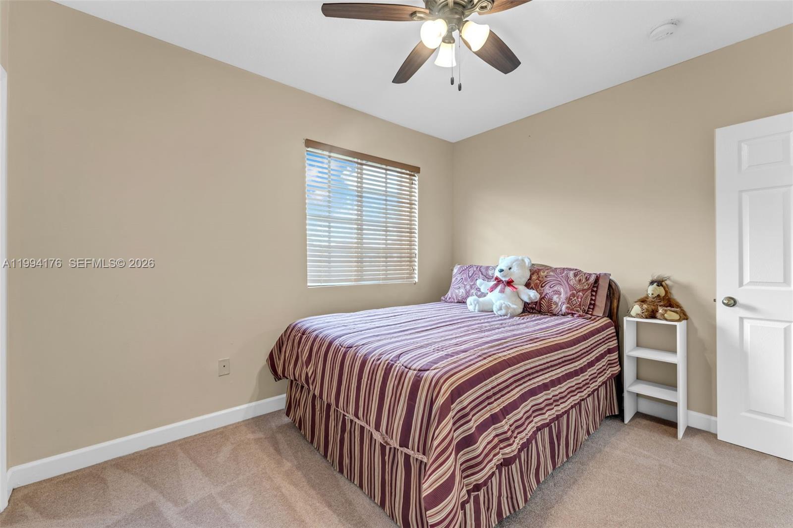 6502 Southwest 157th Court Miami, FL 33193 - Photo 30 of 51 a bedroom with a bed and a chandelier