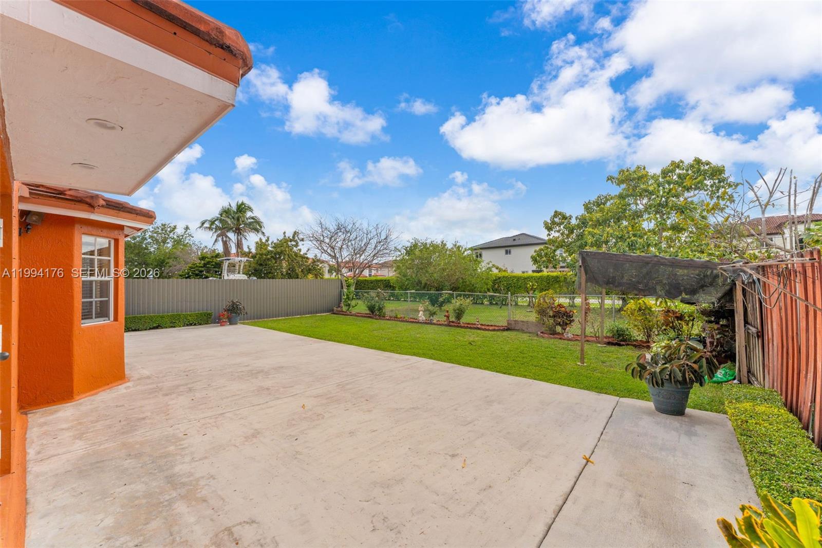 6502 Southwest 157th Court Miami, FL 33193 - Photo 34 of 51 a view of a house with a big yard and potted plants