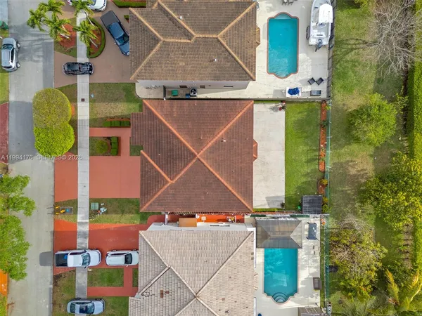 an aerial view of residential houses with outdoor space and river
