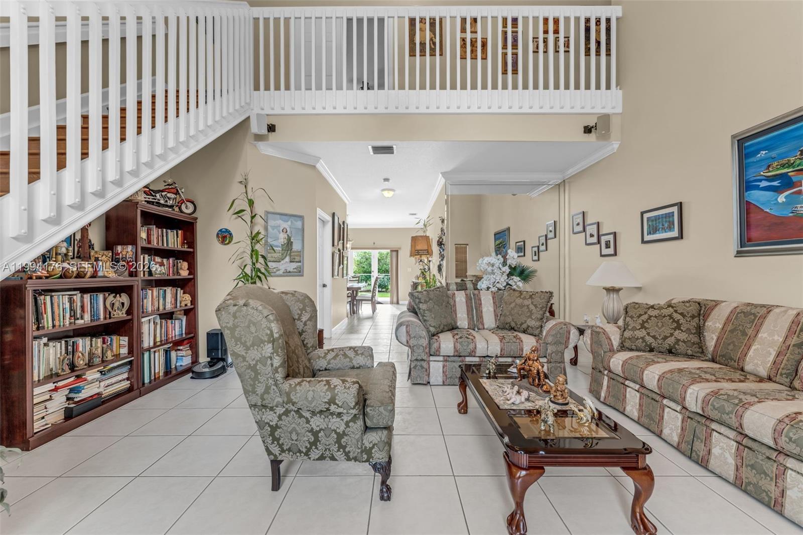 6502 Southwest 157th Court Miami, FL 33193 - Photo 5 of 51 a living room with furniture a rug and a book shelf