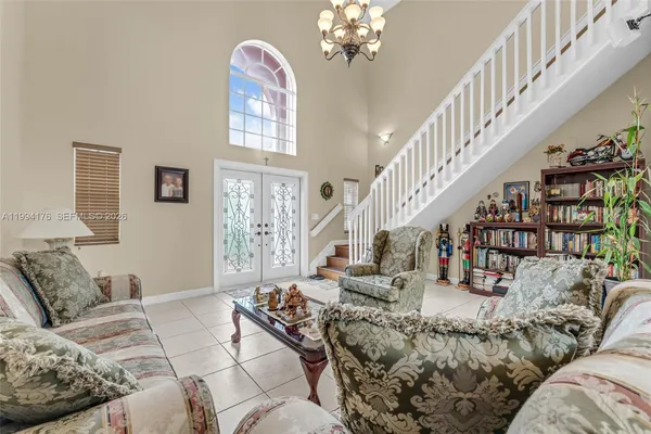 a living room with furniture or stairs and a chandelier