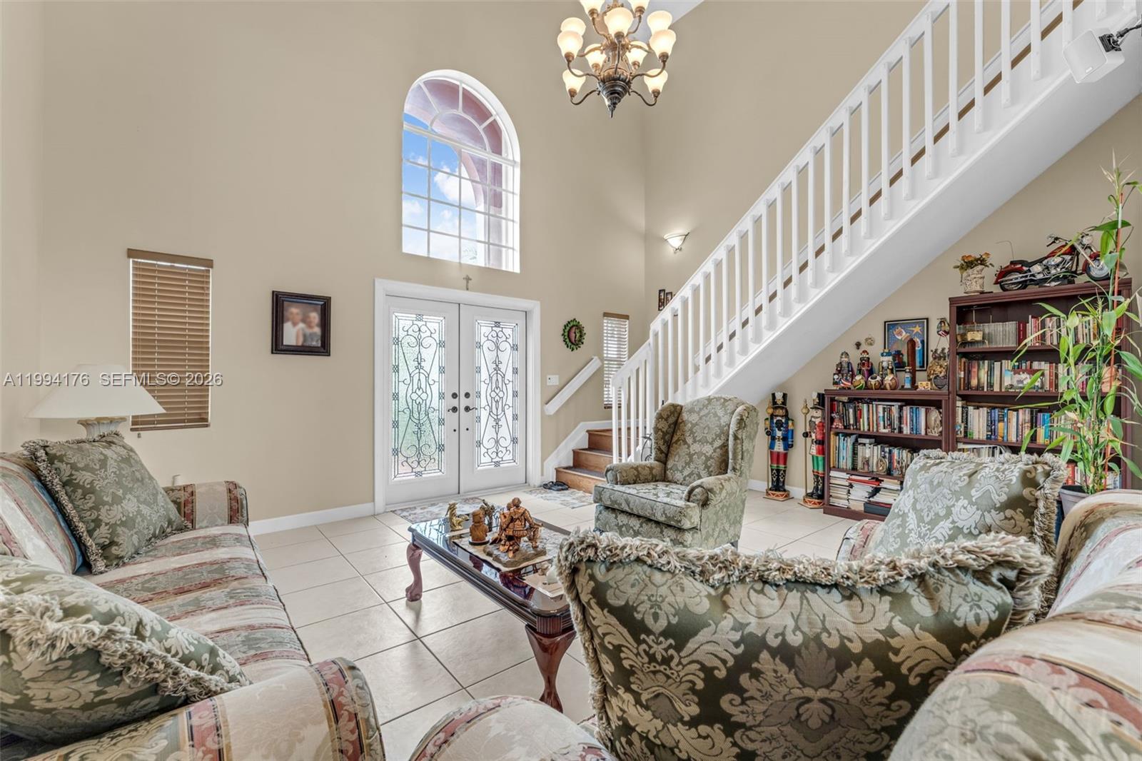6502 Southwest 157th Court Miami, FL 33193 - Photo 6 of 51 a living room with furniture or stairs and a chandelier
