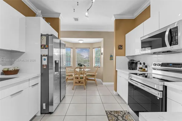 a kitchen with stainless steel appliances a stove a sink and a refrigerator