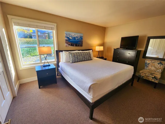 a bedroom with a bed and a couch