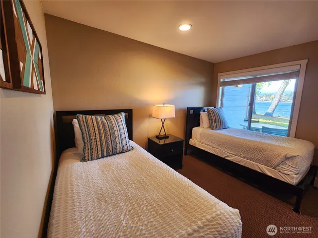 a bedroom with a bed and a night stand