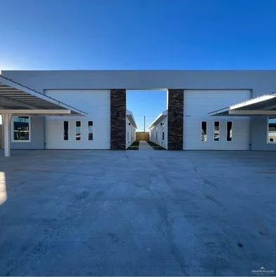 a view of an empty room with two windows
