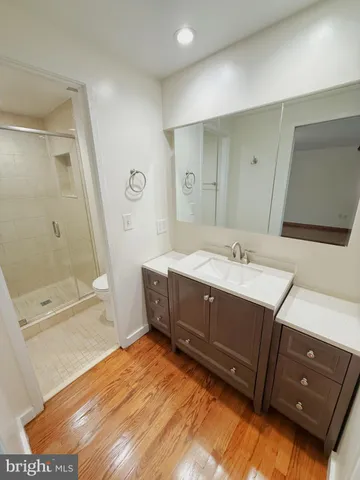 a spacious bathroom with a double vanity sink a mirror and a bathtub