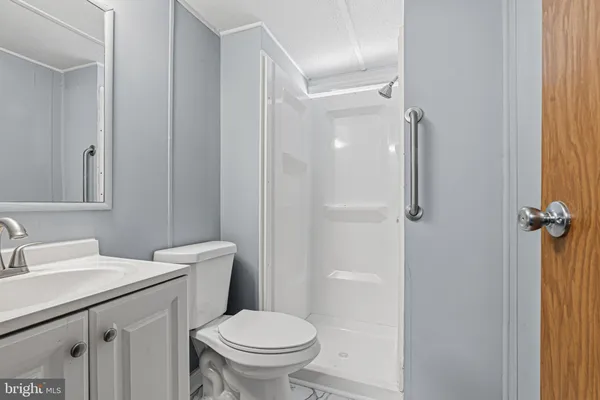a bathroom with a sink a mirror a bathtub and shower