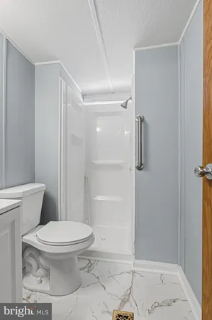 a view of bathroom with a sink toilet and a mirror