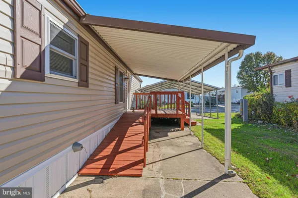 a view of a backyard with table and chairs stairs and a yard