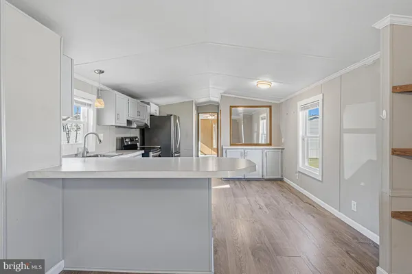 a kitchen with cabinets wooden floor and a sink