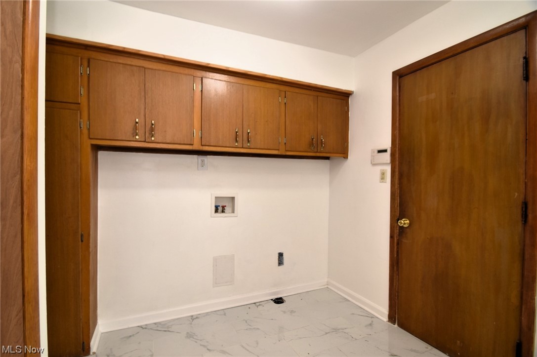 3681 Brinkmore Road Cleveland Heights, OH 44121 - Photo 14 of 27 Laundry room with light tile floors, cabinets, and hookup for a washing machine