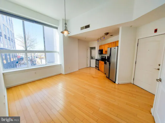 a big room with wooden floor and natural light