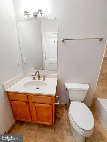 a bathroom with a sink a toilet and mirror