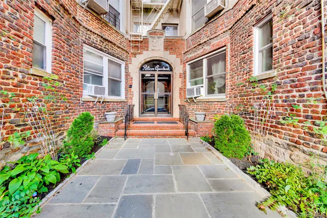 a front view of a brick house with a large windows