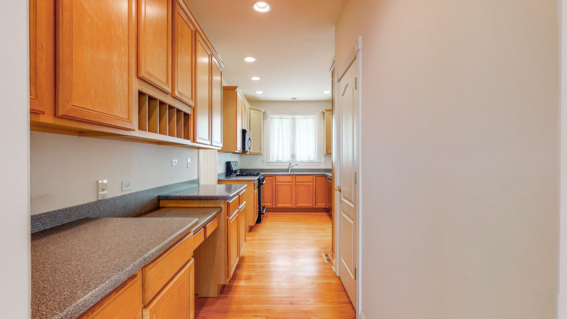 1917 Driving Park Road Wheaton, IL 60187 - Photo 13 of 41 a kitchen with stainless steel appliances granite countertop a sink and cabinets