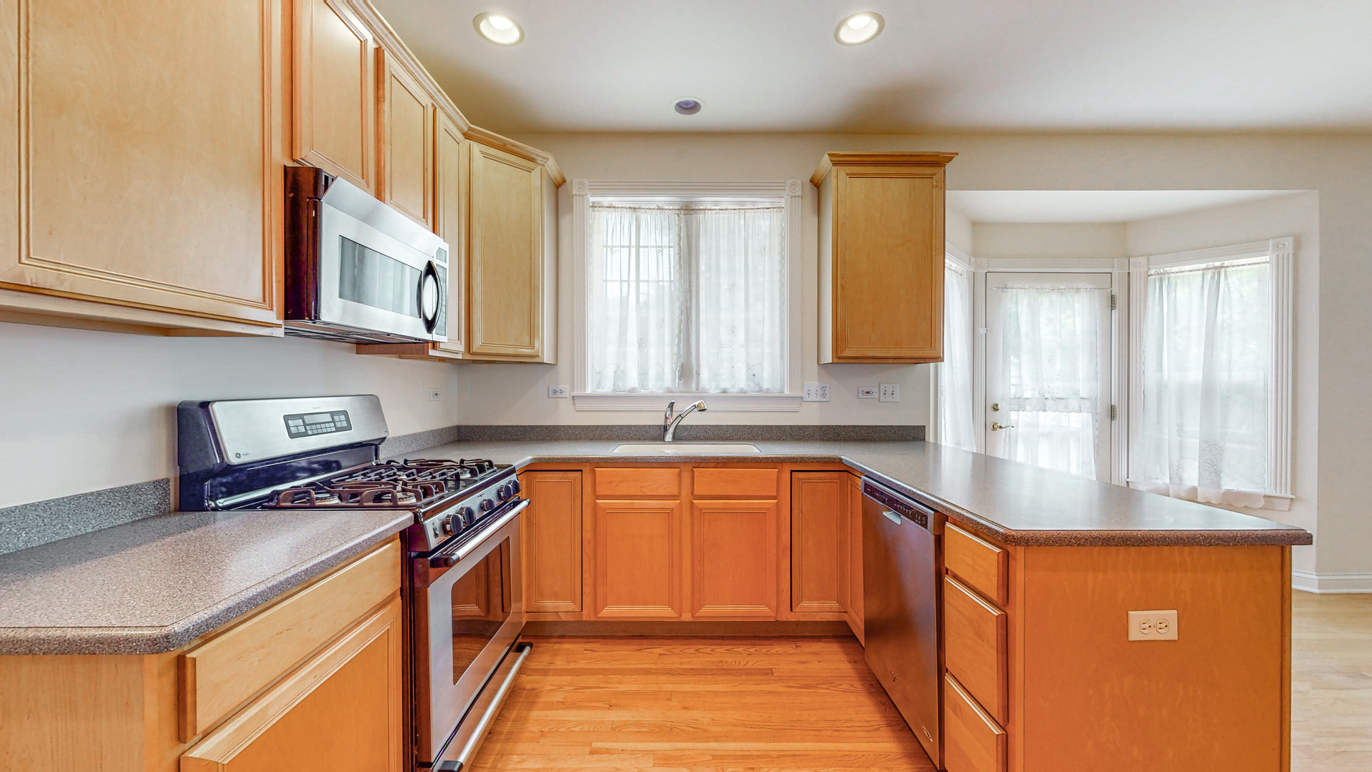 1917 Driving Park Road Wheaton, IL 60187 - Photo 14 of 41 a kitchen with stainless steel appliances granite countertop a sink stove and cabinets