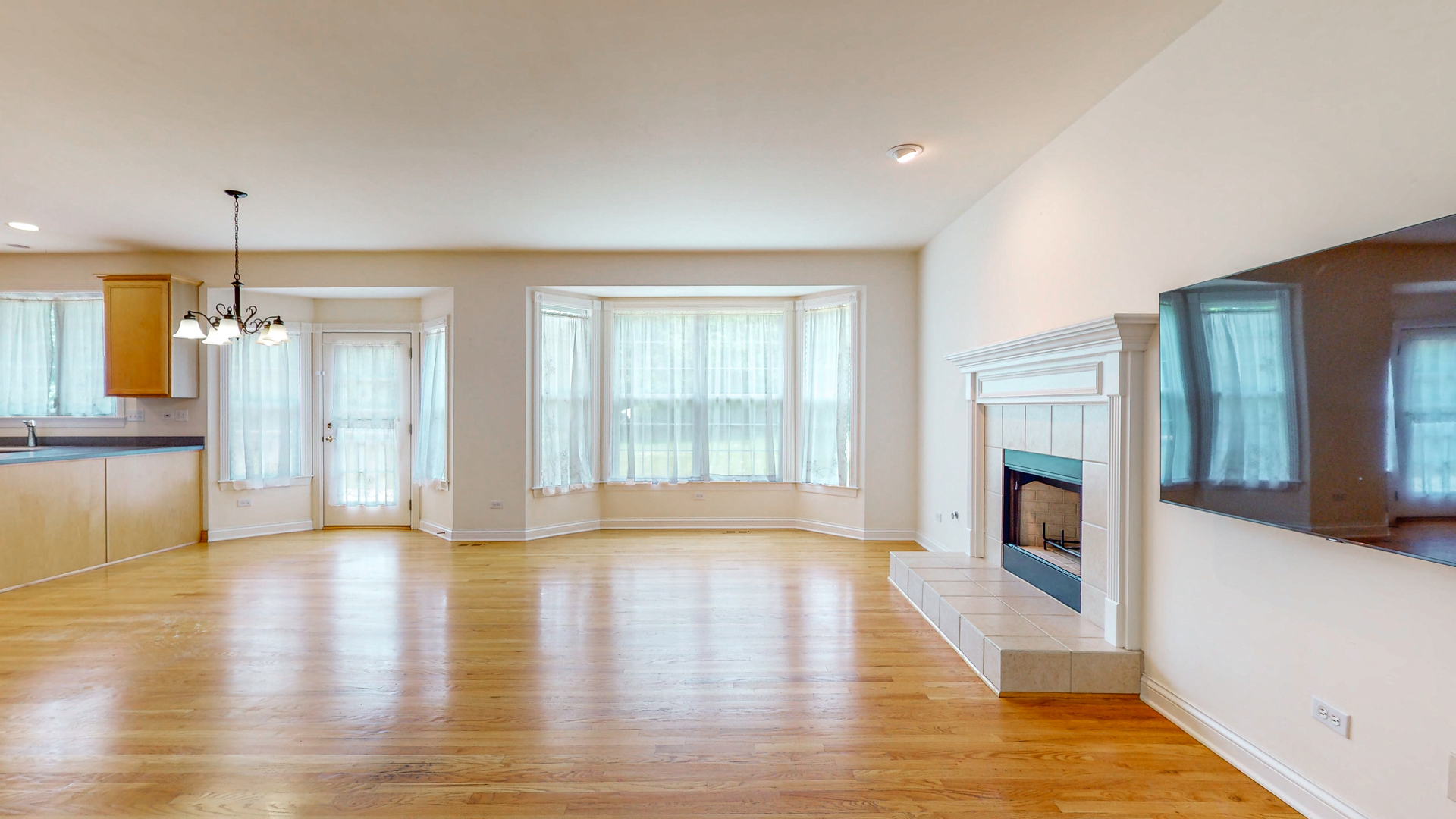 1917 Driving Park Road Wheaton, IL 60187 - Photo 8 of 41 a view of an empty room with wooden floor and a window