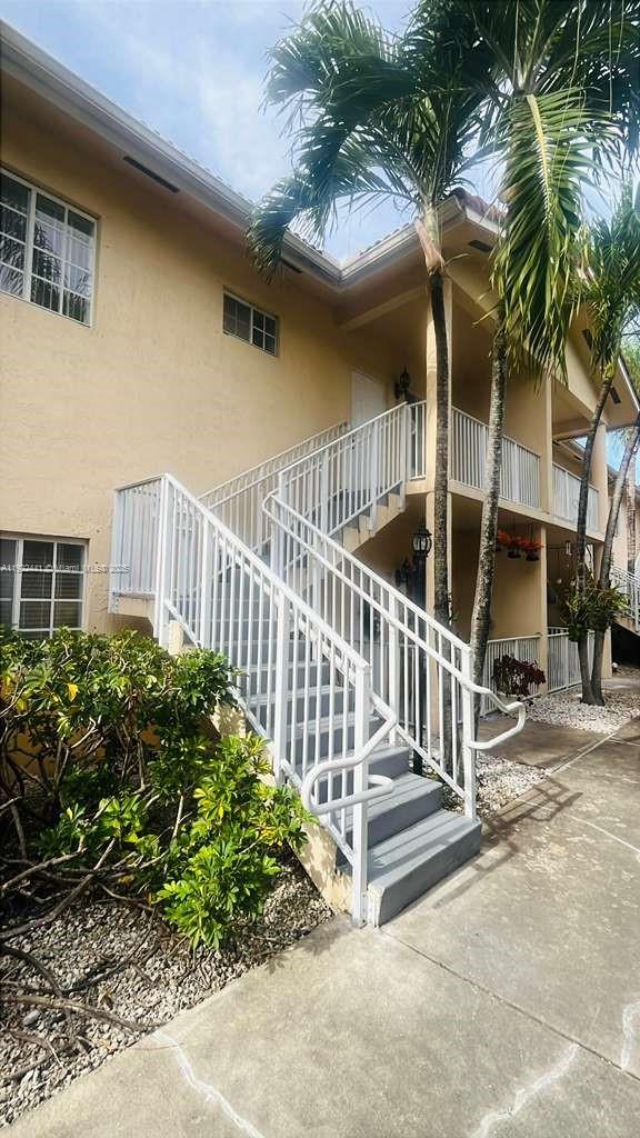 6972 Northwest 179th Street, Unit 2094 Hialeah, FL 33015 - Photo 1 of 10 a view of a house with a small yard and plants