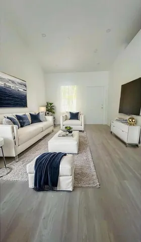 a living room with couches and a flat screen tv