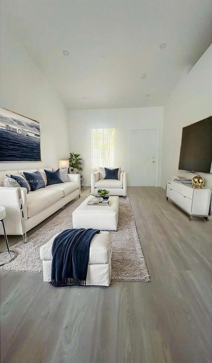 6972 Northwest 179th Street, Unit 2094 Hialeah, FL 33015 - Photo 3 of 10 a living room with couches and a flat screen tv