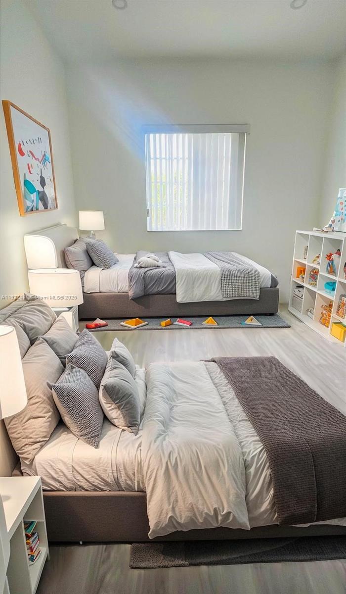 6972 Northwest 179th Street, Unit 2094 Hialeah, FL 33015 - Photo 7 of 10 a bedroom with a bed and a couch