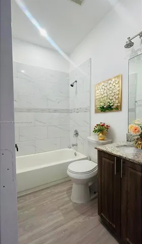 a bathroom with a sink a toilet and bathtub