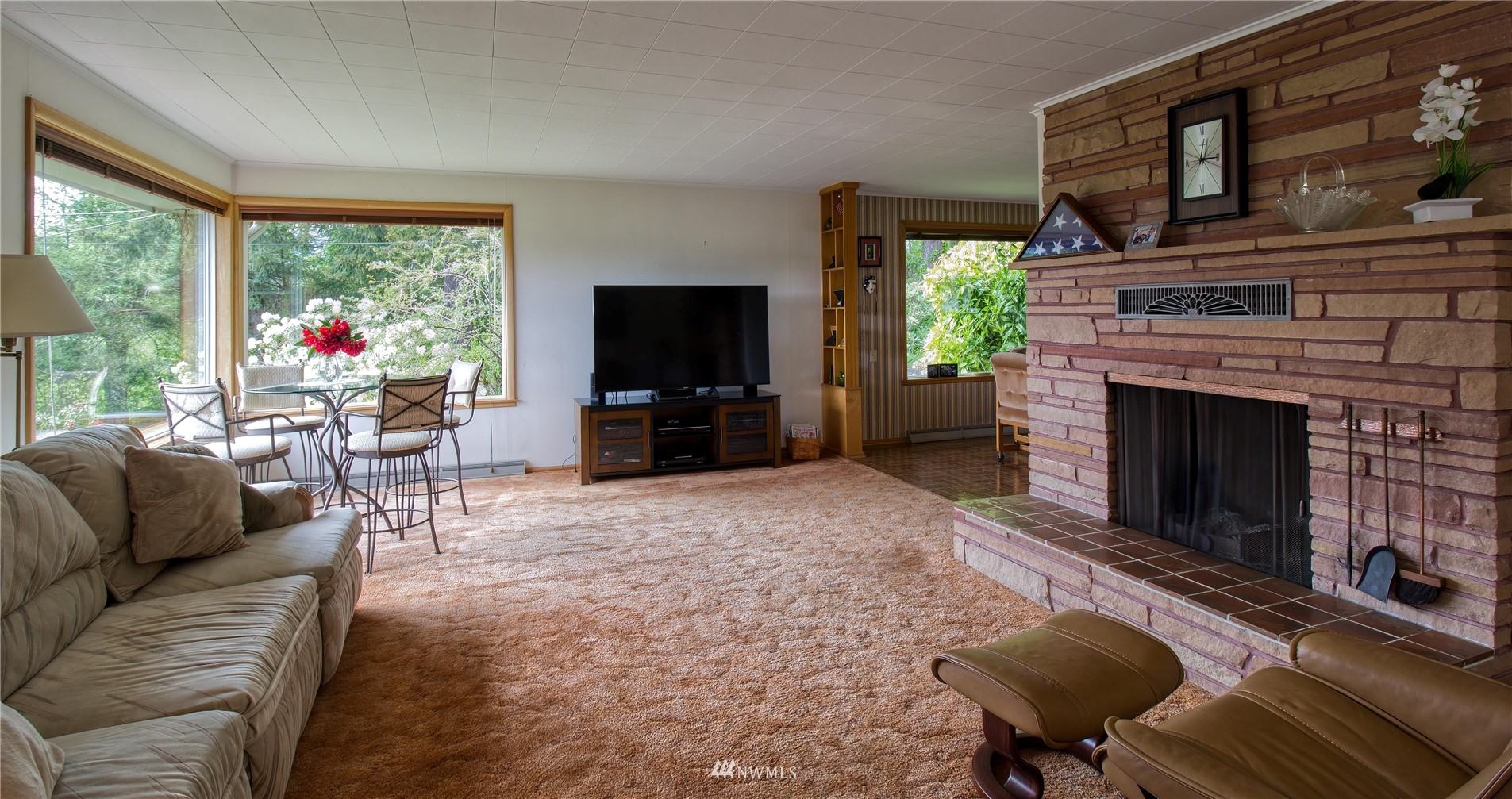 14310 Center Road Quilcene, WA 98376 - Photo 14 of 32 a living room with furniture a flat screen tv and a fireplace