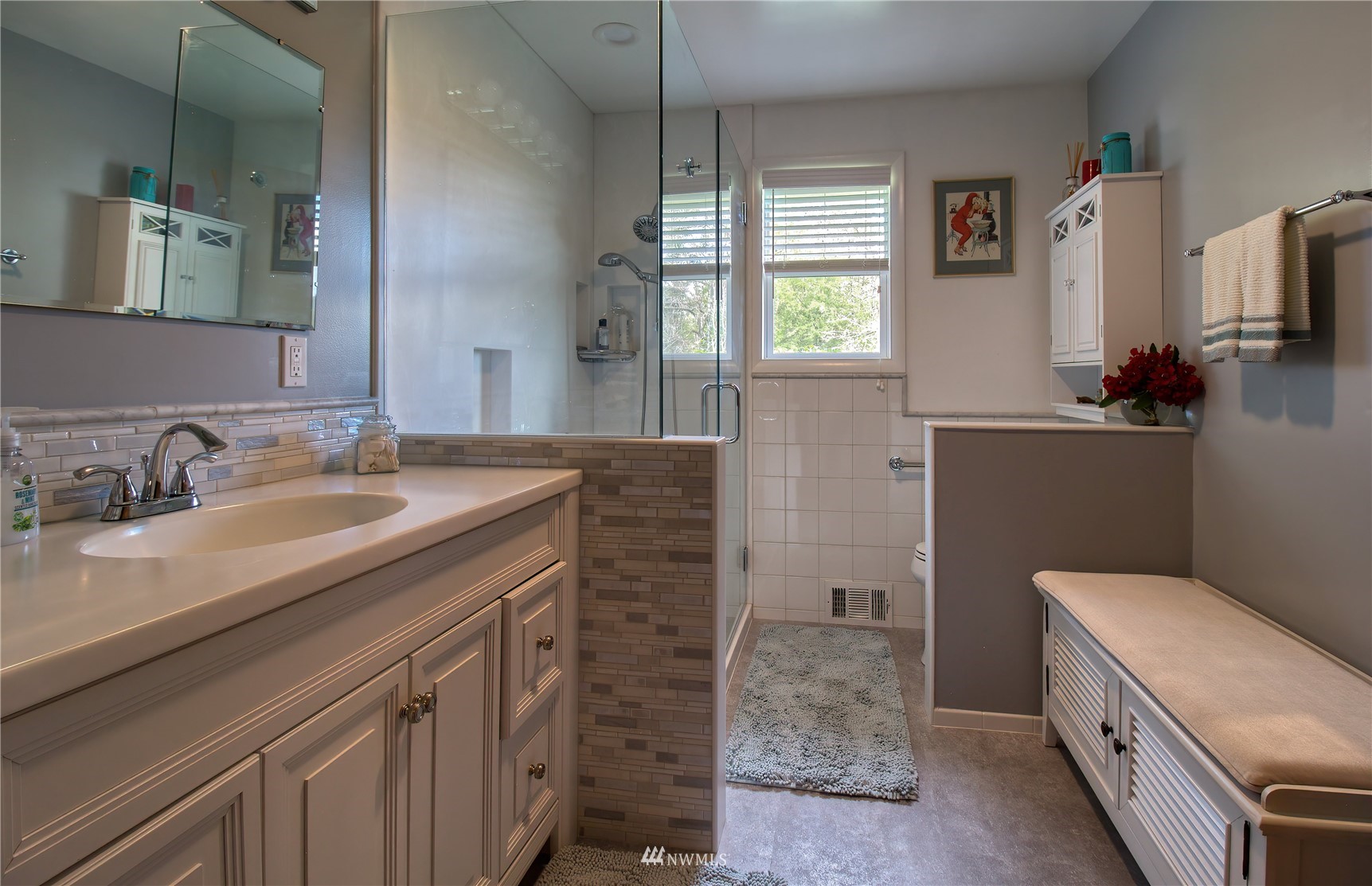 14310 Center Road Quilcene, WA 98376 - Photo 9 of 32 a bathroom with a granite countertop sink a toilet and a mirror