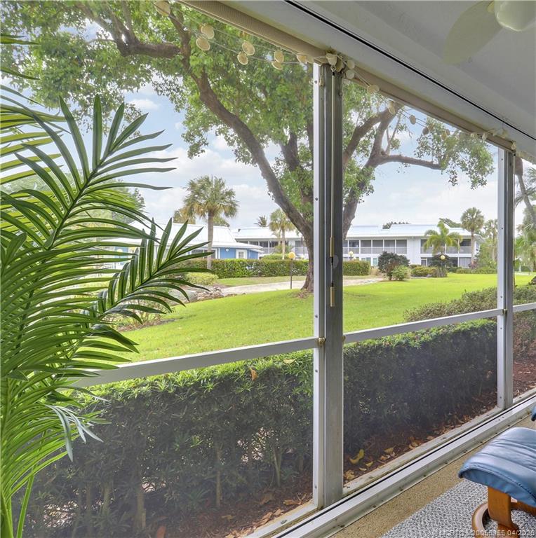 1862 Southwest Palm City Road, Unit 103 Stuart, FL 34994 - Photo 20 of 29 From the lanai looking to the Clubhouse & pool - gorgeous tree and green area