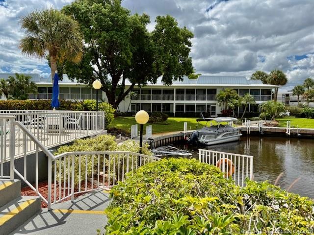 1862 Southwest Palm City Road, Unit 103 Stuart, FL 34994 - Photo 23 of 29 Gorgeous tree is right outside your lanai - The main Clubhouse and pool is close but not too close