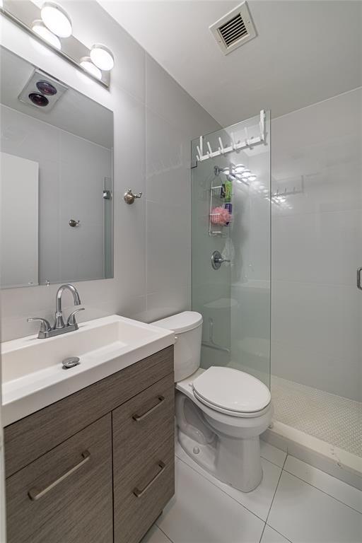 2100 Northeast 38th Street, Unit 216 Lighthouse Point, FL 33064 - Photo 13 of 27 a bathroom with a sink a toilet and shower