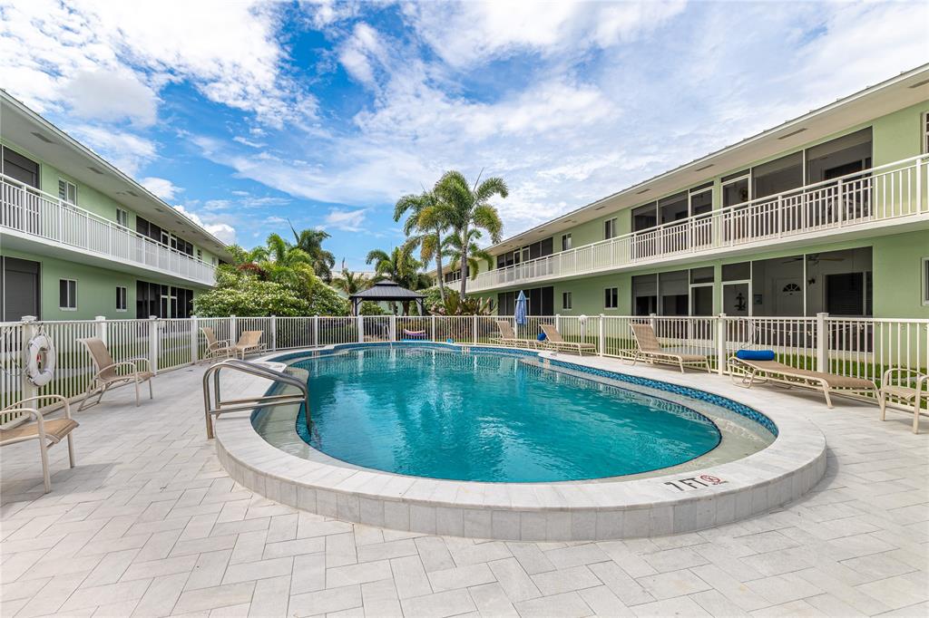 2100 Northeast 38th Street, Unit 216 Lighthouse Point, FL 33064 - Photo 19 of 27 a view of a swimming pool with a patio
