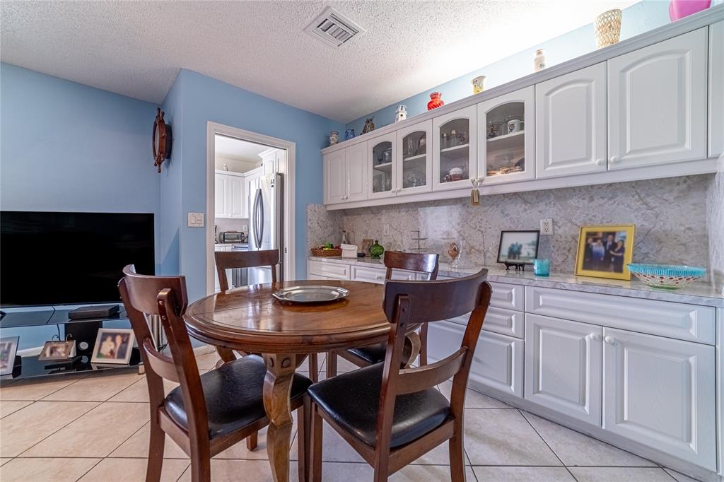 2100 Northeast 38th Street, Unit 216 Lighthouse Point, FL 33064 - Photo 4 of 27 a view of a dining room with furniture and a kitchen